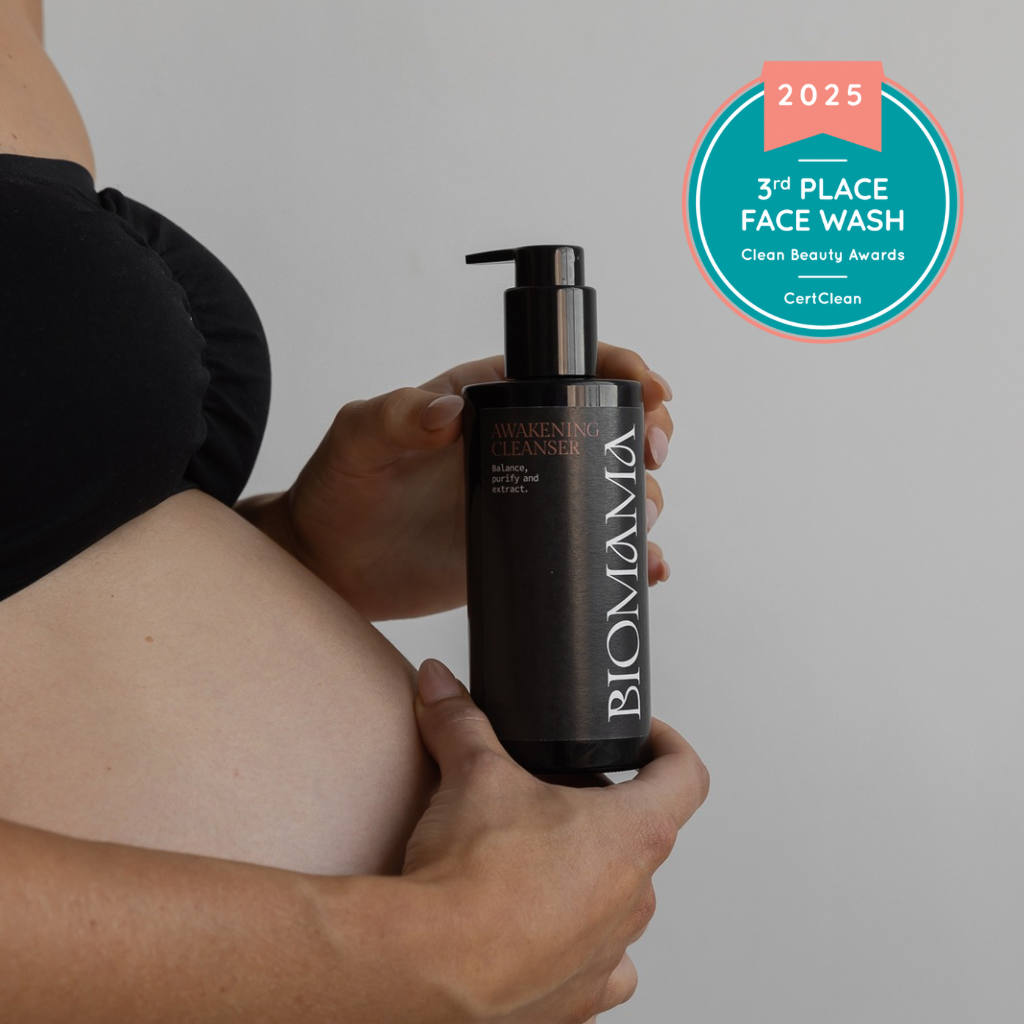 Biomama Skincare award winning Awakening Cleanser in the hands of a pregnant women